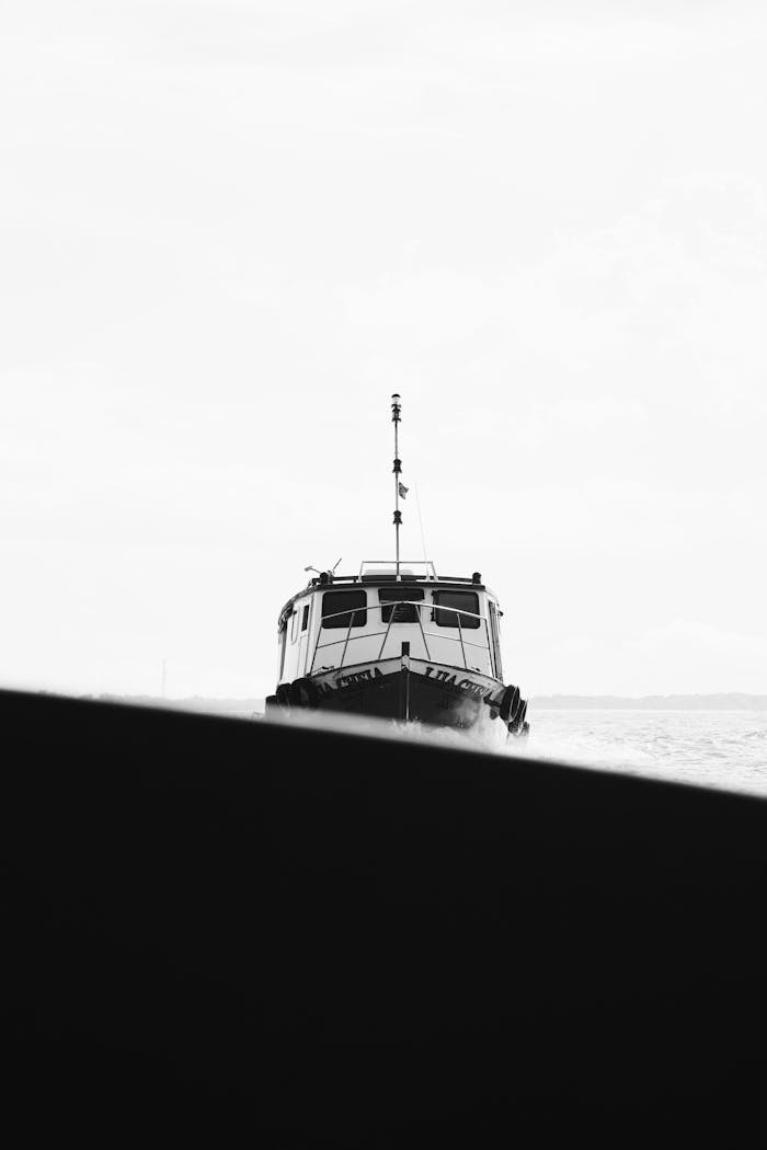 A monochrome image of a boat navigating the waters in Paranaguá, Brazil.